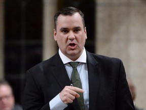 Industry Minister James Moore responds to a question during question period in the House of Commons on Parliament Hill in Ottawa on Monday, April 28, 2014. The federal government offered a new source of hope for Canada's small wireless companies on Monday, giving them a shot at high-quality wireless spectrum earlier than expected and limiting how much can be purchased by the largest players.