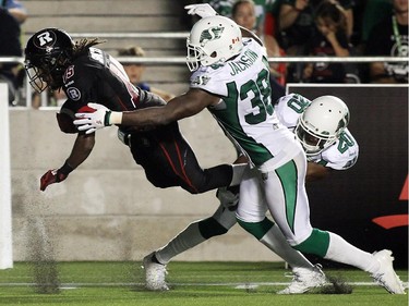 Jamill Smith (15) of the Ottawa Redblacks is tackled by Tristan Jackson (38) and Terrell Maze (20) of the Saskatchewan Roughriders during the second half of CFL game action at TD Place in Ottawa on Saturday, Aug. 2, 2014.