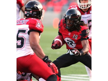 Jamill Smith #15 of the Ottawa Redblacks tries to get past Karl McCartney #45 of the Calgary Stampeders during a CFL match at TD Place in Ottawa on August 24, 2014.