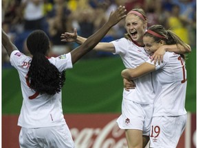 Canada's Janine Beckie celebrates her goal against North Korea with teammates Valerie Sanderson, right, and Nichelle Prince, left, during second half FIFA U20 Women's World Cup soccer action Tuesday, August 12, 2014 in Montreal. Canada won 1-0.
