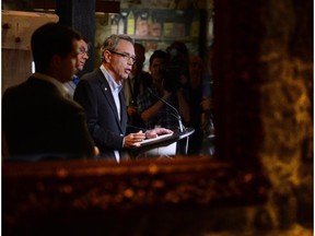 Minister of Finance Joe Oliver speaks to media prior to holding a Summer Policy Retreat in Wakefield, Que., on Tuesday, Aug. 12, 2014.