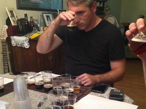 Joe Rancourt sniffs a sample of beer before judging it for the National Capital Homebrew Competition.