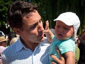 Liberal Leader Justin Trudeau holds his 5-month-old son Hadrien while attending the B.C. Day Liberal barbeque in Vancouver, B.C., on Monday August 4, 2014.