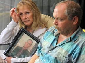 Kathy Morlang wipes away tears while holding a picture of her son and describing what a hard worker he was. A year after their son Michael Morlang was struck and killed in a hit and run on Frank Kenny Road, his parents, Brian Visneskie and Kathy Morlang, are still looking for answers.