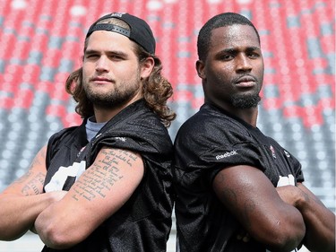 Linebackers Travis Brown (left) and Jasper Simmons strike tough guy poses after practice.  Ottawa Redblacks run through a light practice Thursday, August 14, 2014 at TD Place stadium before Friday night's home game against the Edmonton Eskimos.