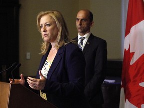 Transport Minister Lisa Raitt speaks to the media along with Minister of Public Safety Steven Blaney following the release of the Transportation Safety Board's final report on the train derailment in Lac-Megantic, Que.