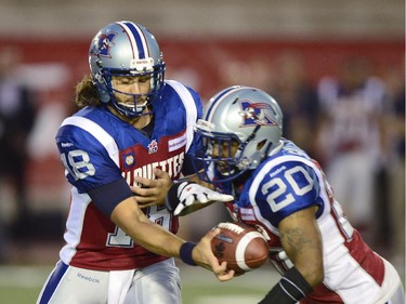Montreal Alouettes QB Jonathan Crompton (18) hands off to Tyrell Sutton during CFL first quarter action against the Ottawa Redblacks in Montreal on Friday Aug. 29, 2014.