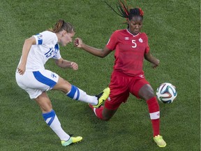 Finland's Natalia Kuikka (left) gets a shot away as Canada's Kadeisha Buchanan defends during first half action in 2014 FIFA U-20 Women's World Cup action, in Toronto on Friday August 8, 2014.