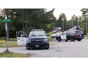 Officers from the Ontario Provincial Police's tactical response unit man the entrance of Labine Cresent in Petawawa, Ontario on Friday Aug. 29, 2014. Provincial police are continuing a standoff with a man inside a house near Petawawa.