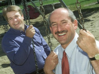 Regional Coun. Peter Hume and Ottawa Coun. Allan Higdon sit on swings at the Grasshopper Park in Ottawa on September 5, 2000 as part of their election kickoff.