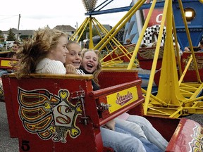Taylor Sullivan, Sara Benett, and Emily Terry, all of Russell, hit the rides.