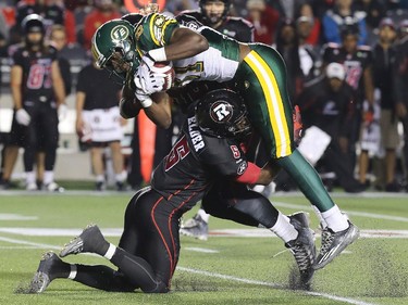 Ottawa defensive back Eddie Elder heaves Edmonton's Devon Bailey into the air during a key tackle in the first half during the Ottawa Redblacks Friday night matchup against the Edmonton Eskimos at TD Place in Ottawa, August 15, 2014.