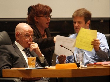Councillors Jan Harder and Peter Hume, right, confer as mayor Larry O'Brien, left, looks on during Ottawa city council budget deliberations at Andrew Hayden Room at Ottawa City Hall on December 12, 2007.