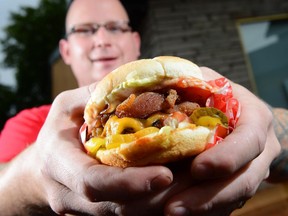 Thomas Williams of Hintonburger, holds the Hintonburger, which won the Citizen's best burger poll in 2012. Will it win Le Burger Week in 2014?