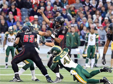 Ottawa QB Henry Burris gets tackled after the release during the Ottawa Redblacks Friday night matchup against the Edmonton Eskimos at TD Place in Ottawa, August 15, 2014.