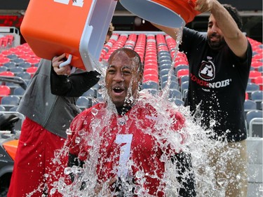 Ottawa Redblacks quarterback Henry Burris gets doused with two ice chests full of freezing water after practice Thursday -  all for a good cause, however. The Ice Bucket Challenge has become a viral sensation to raise money for ALS.