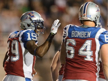 S.J. Green #19 of the Montreal Alouettes celebrates his first half touchdown with teammates against the Ottawa Redblacks during the CFL game at Percival Molson Stadium on August 29, 2014 in Montreal.