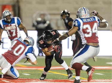 Marc-Olivier Brouillette #10 of the Montreal Alouettes tackles Khalil Paden #13 of the Ottawa Redblacks during the CFL game at Percival Molson Stadium on August 29, 2014 in Montreal.