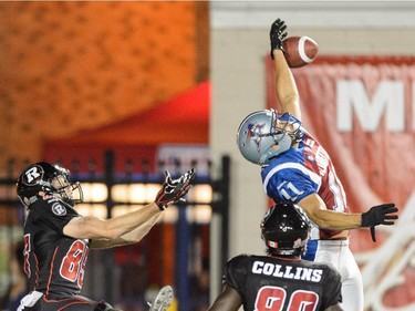 Chip Cox #11 of the Montreal Alouettes intercepts a pass intended for Onrea Jones #89 of the Ottawa Redblacks during the CFL game at Percival Molson Stadium on August 29, 2014 in Montreal.