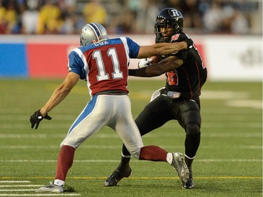 Marcus Henry #16 of the Ottawa Redblacks shakes off Chip Cox #11 of the Montreal Alouettes during the CFL game at Percival Molson Stadium on August 29, 2014 in Montreal.