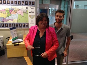 Ottawa Sun columnist Susan Sherring, pictured with her son Peter Knowlton, registers to run for city council at Ben Franklin Place Thursday morning. She is running in Gloucester-South Nepean ward.