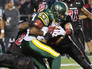 Ottawa's Jermaine Robinson and Travis Brown (right) take down Edmonton's Shamawd Chambers during the Ottawa Redblacks Friday night matchup against the Edmonton Eskimos at TD Place in Ottawa, August 15, 2014.