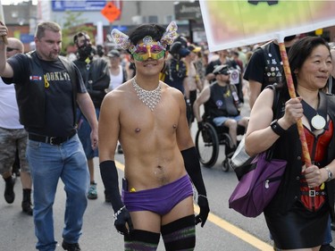 Participants in the Capital Pride Parade march on Bank Street on Sunday, Aug. 24, 2014.