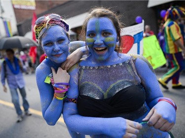 Participants in the Capital Pride Parade smile for the camera as they march on Bank St. on Sunday, Aug. 24, 2014.