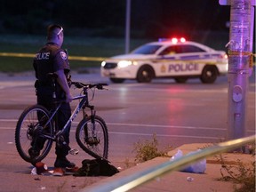 Police investigate a serious car-bicycle collision at the intersection of Woodroffe Avenue and Knoxdale Road, August 30, 2014.