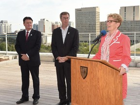 Premier Kathleen Wynne officially opens Ottawa Tourism�s new Elgin Street offices on Monday morning, as Mayor Jim Watson and Ottawa Tourism president and chief executive Noel Buckley look on. Monday, Aug. 11, 2014.

Photo Courtesy Roger Lalonde, City of Ottawa