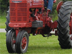 In this Sunday, Aug. 24, 2014, photo, Rick Rector, of Avoca, Mich., ride a tractor with his grandson, Bryce Rector, 8, during the St. Clair County Farm Museum's Steam Show and Old Fashion Harvest Days at Goodells County Park in Wales, Mich.