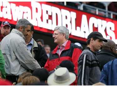 Prime Minister Stephen Harper meets people during the Ottawa Redblacks Friday night matchup against the Edmonton Eskimos at TD Place in Ottawa, August 15, 2014.