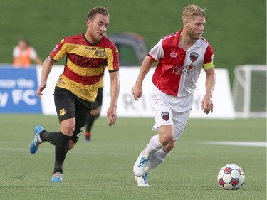 Richie Ryan #6 of the Ottawa Fury against breaks down the field against Stefan Antonijevic #2 of the Fort Lauderdale Strikers during an NASL match at TD Place in Ottawa on August 9, 2014.