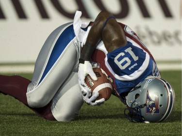 Montreal Alouettes slotback S.J. Green catches a low pass in the end zone for a touchdown as they face the Ottawa Redblacks during first quarter CFL football action Friday, August 29, 2014 in Montreal.