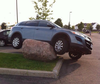 And then there’s this strangely incompetent photo of an SUV mounted a top a large boulder in a Shopper’s Drug Mart parking lot.