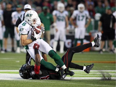 Seth Williams of the Ottawa Redblacks tackles Rob Bagg of the Saskatchewan Roughriders during the first half of CFL game action at TD Place in Ottawa on Saturday, Aug. 2, 2014. (Cole Burston/Ottawa Citizen)