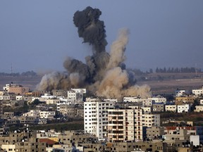 Smoke and sand rise after an Israeli strike in Gaza City on Saturday.