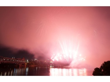 Smoke hides the Parliament Buildings during the Casino du Lac-Leamy Sound of Light fireworks as viewed from the Canadian Museum of History along Ottawa River in Gatineau (Quebec), Saturday, August 2, 2014.