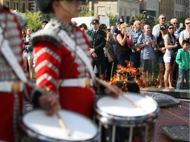 Spectators watch as the Ceremonial Guard performs on Parliament Hill one last time on the last performance of the season, Saturday, Aug. 23, 2014.