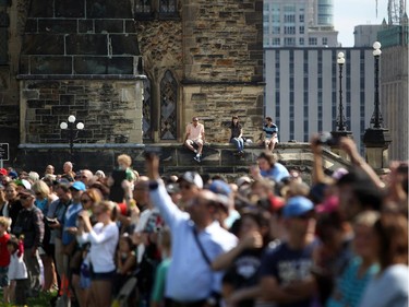 Spectators watch as the Ceremonial Guard performs on Parliament Hill one last time on the last performance of the season, Saturday, Aug. 23, 2014.