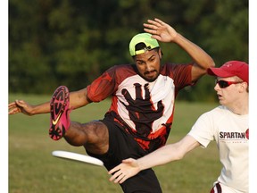 Stephane Joseph, left, tries to block Jeff Nuyens during a pickup game of ultimate frisbee in Ottawa.