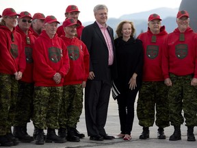 Prime Minister Stephen Harper and wife Laureen pose for a photograph with the Canadian Rangers in Whitehorse on Friday.
