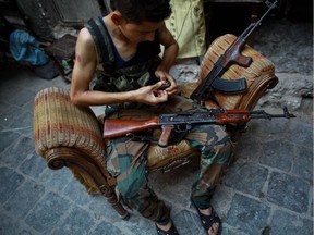 A rebel fighter from the Islamic Front, an umbrella of Islamist rebel groups in Syria, reloads weapons before fighting government forces in the old city of Aleppo on July 21, 2014. Aleppo was Syria's most populous city before the conflict, but it is now a major battle zone split into areas controlled by the rebels concentrated in the east and those held by the government mainly in the west.