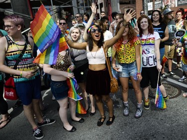 The crowd cheers on the parade at the Capital Pride Parade on Bank St. on Sunday, Aug. 24, 2014.