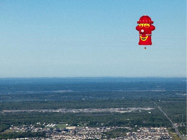 The Fire Hydrant, piloted by Jean-Francois Ferland, floats over Gatineau Friday, August 29, 2014.