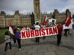 The Kurdish Community of Ottawa held a protest against the actions of the Islamic State of Iraq and the Levant (ISIL), better known to some as the Islamic State of Iraq and Syria (ISIS), in front of Parliament Hill on August 13, 2014.  (David Kawai / Ottawa Citizen)