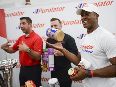 The Ottawa  Redblacks QB, Henry Burris  at the Ottawa Food Bank for Purolator Tackle Hunger weekend on Thursday, Aug. 14, 2014. Fans attending the Redblacks and Fury FC games in Aug. 15 and 17 are encouraged to bring non-perishable food items or cash donations to the volunteers stationed at the stadium gates. Fans will have the opportunity to have a photo taken with the Grey Cup and North American Soccer League (NASL) Soccer Bowl trophy.