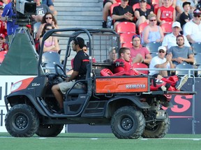 Thomas DeMarco #17 of the Ottawa Redblacks is taken off the field after sustaining an injury during a CFL match against the Calgary Stampeders at TD Place in Ottawa on August 24, 2014. (Jana Chytilova / Ottawa Citizen)  ORG XMIT: 0824 RedBlacks 25