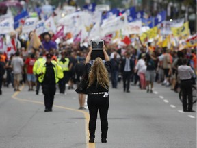 Three separate groups of protesters, organized by Peoples Social Forum, marched down Wellington Street to Parliament Hill on Thursday, Aug. 21, 2014.