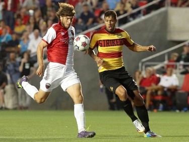 Tom Heinemann #9 (L) of the Ottawa Fury goes against Rafael Alves #33 (R) of the Fort Lauderdale Strikers during an NASL match at TD Place in Ottawa on August 9, 2014.